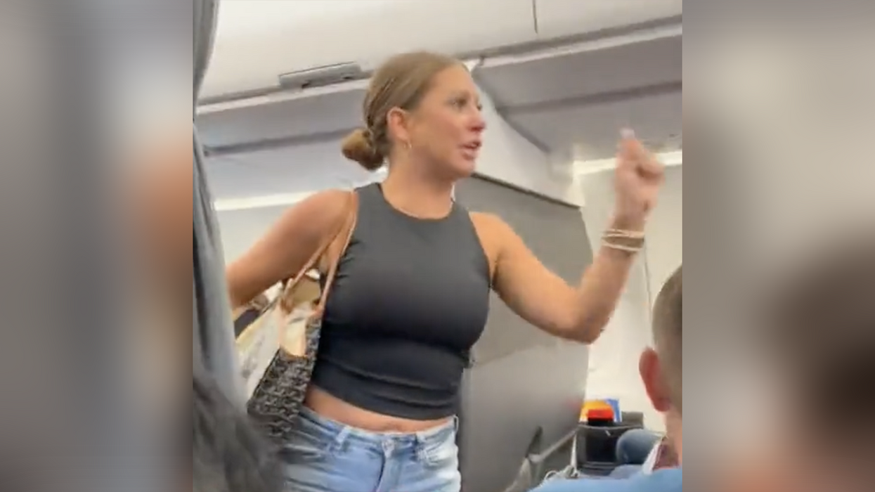 A woman freaks out on American Airlines over passenger she says is not real.