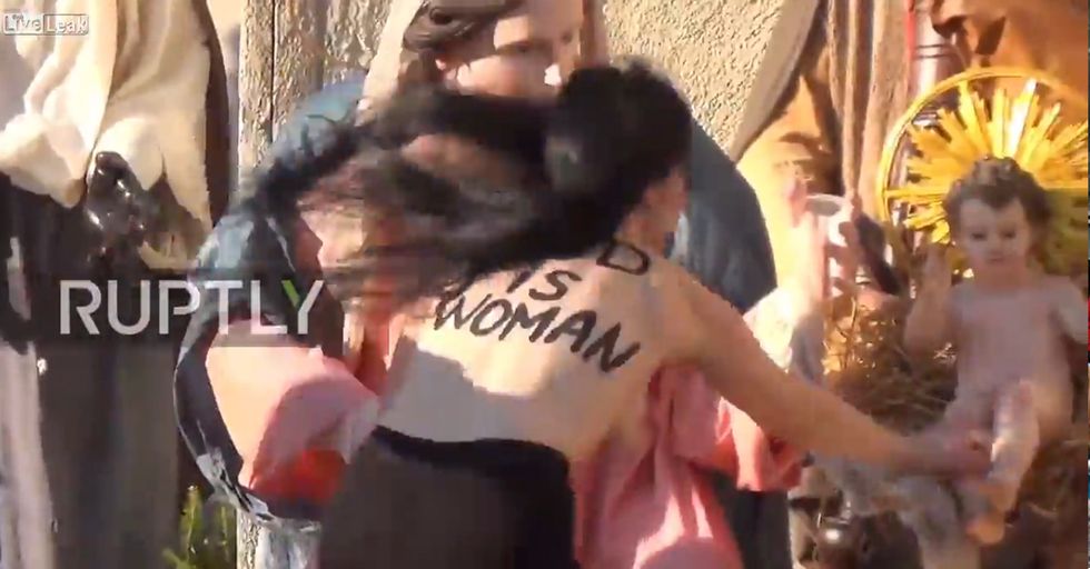 WATCH: Crazed Feminist Tries Stealing Baby Jesus. Of Course She's Topless...