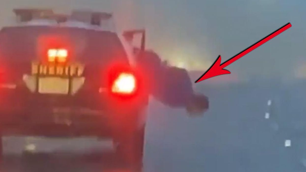 Watch: Handcuffed prisoner tries to escape head first out of a police car window. SPOILER: He fails.