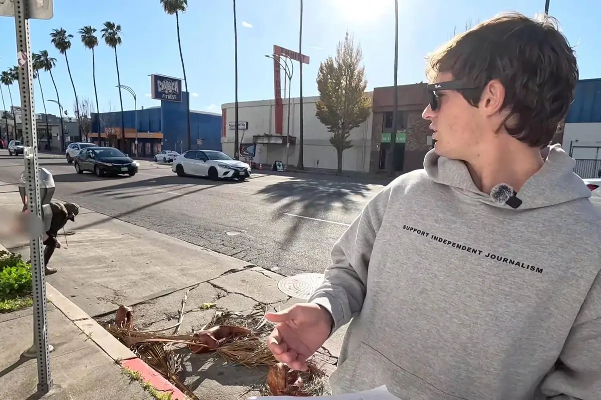 As Nick Shirley exposes California hospice fraud, a woman exposes herself behind him and mistakes street for toilet