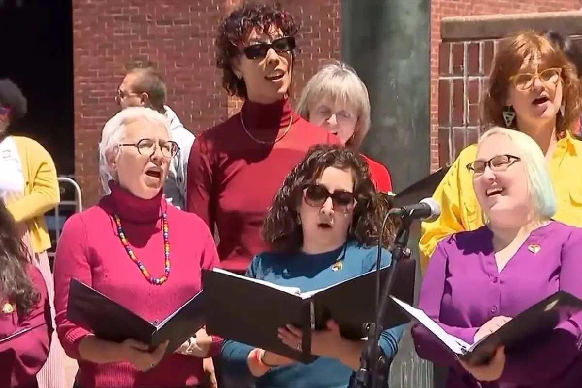 Gay Pride conquers Boston as its flag is raised above City Hall as the choir sings