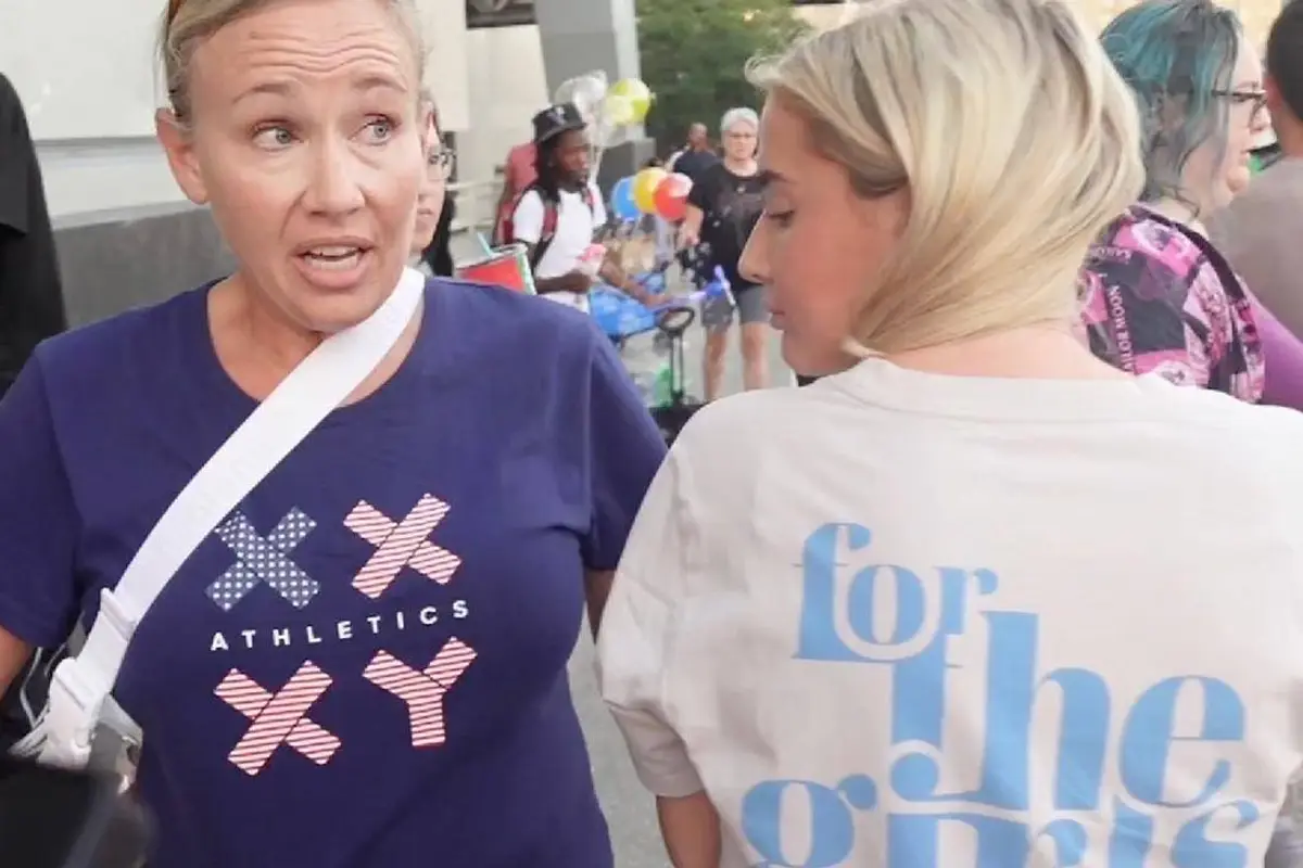Two women forced to cover up their pro-women's sports t-shirts at a WNBA game