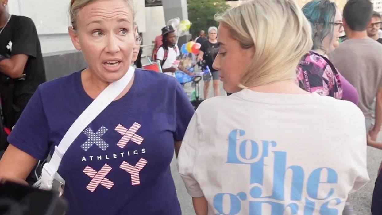 Two women forced to cover up their pro-women's sports t-shirts at a WNBA game