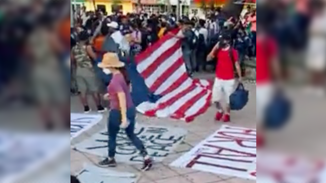 Watch: Migrant Caravan Marches Towards Border Flying American Flag Without Stars: 'Joe Biden is for All'
