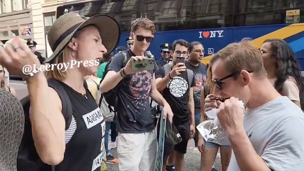 Watch: Instant legend trolls animal rights activists by eating meat in their faces, and they can't deal