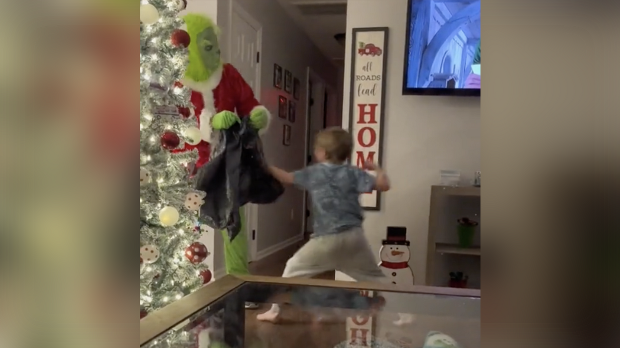 Watch: Grinch 'prank' goes horribly wrong when lil' man starts throwing hands to save his presents