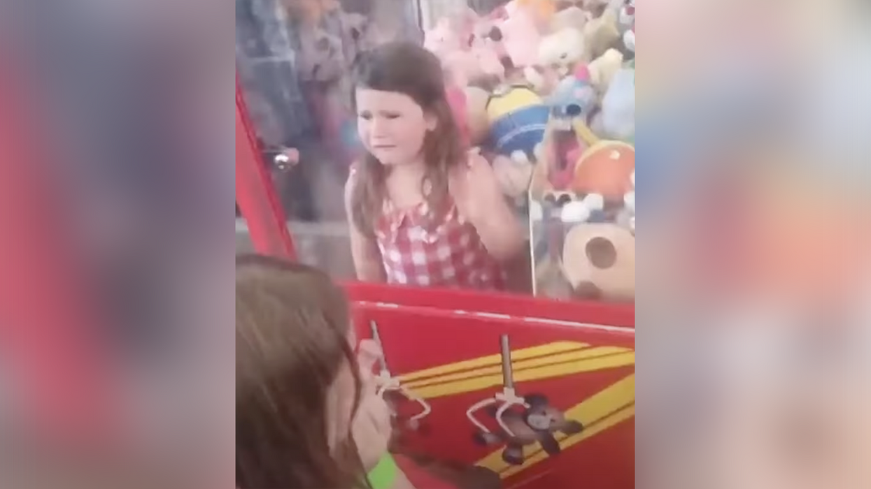 Watch: Little girl gets stuck in a claw machine when her sister dared her to climb in and it's hard not to laugh