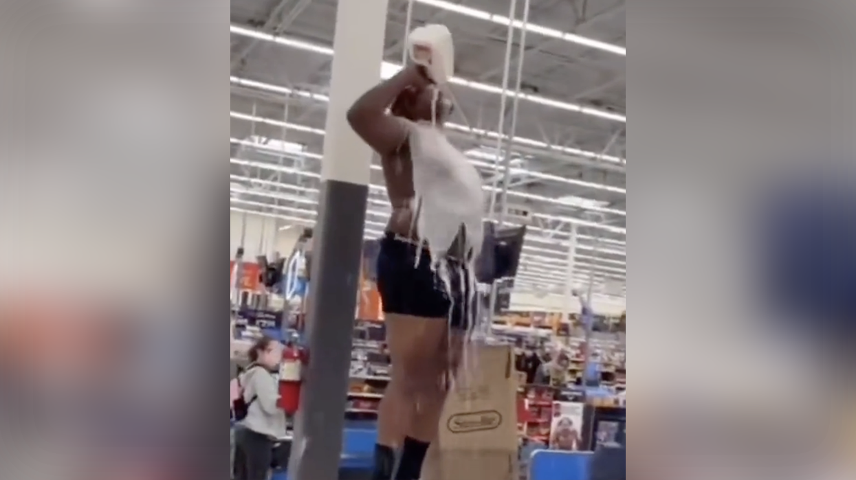 Watch: Half-naked dude leaps on register and pours milk on himself because that's what happens at Walmart these days
