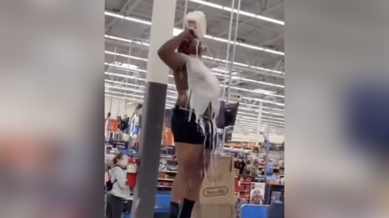 Watch: Half-naked dude leaps on register and pours milk on himself because that's what happens at Walmart these days