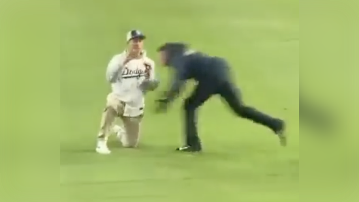 Watch: Baseball fan's proposal goes hysterically wrong when he gets plowed into centerfield by security