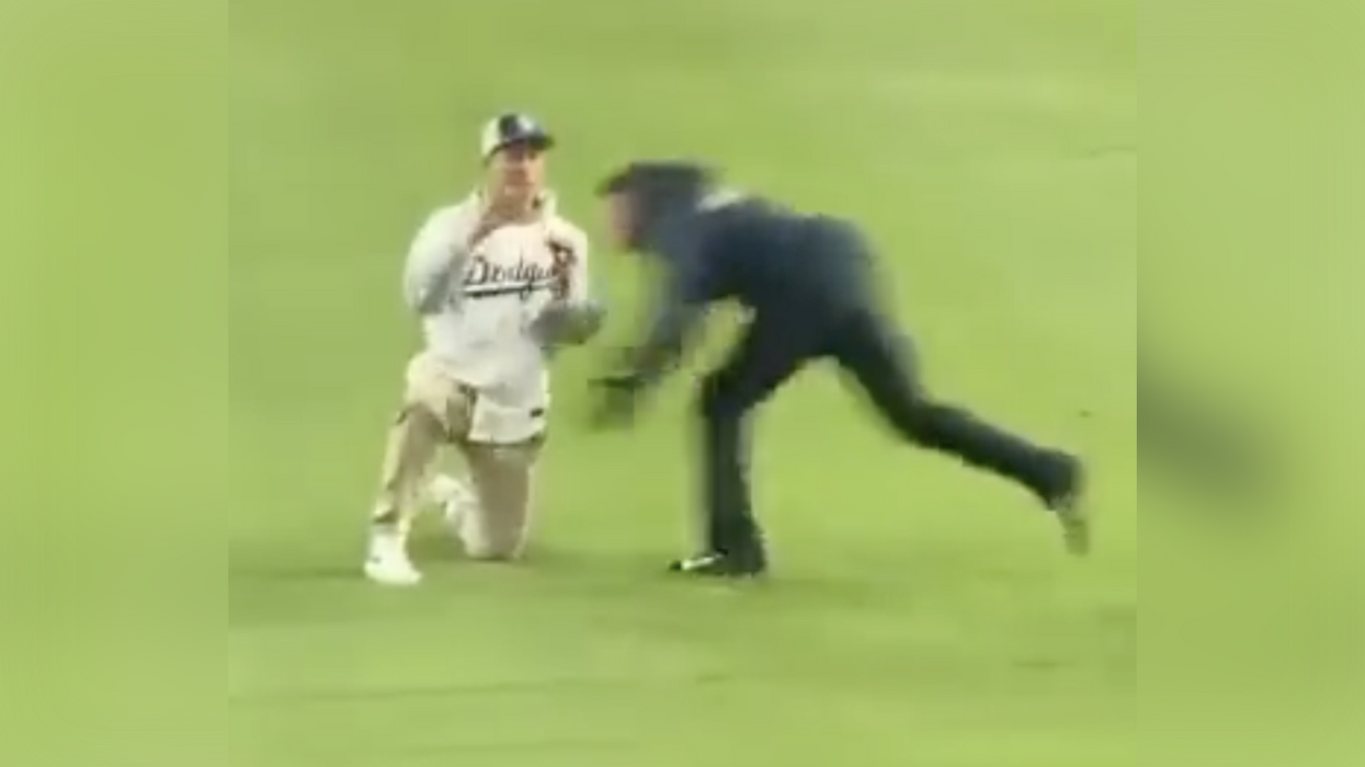 Watch: Baseball fan's proposal goes hysterically wrong when he gets plowed into centerfield by security