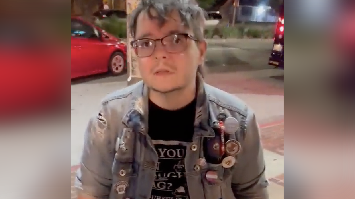 Watch: This guy's (?) busted ripping down photos of Jewish hostages, claims hostages didn't consent to have their photo used