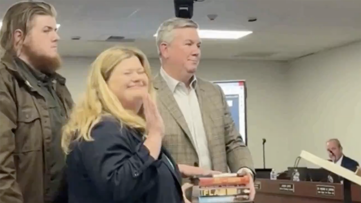 Watch: School board president shuns Bible, gets sworn in on p0rnographic books "banned" from schools instead