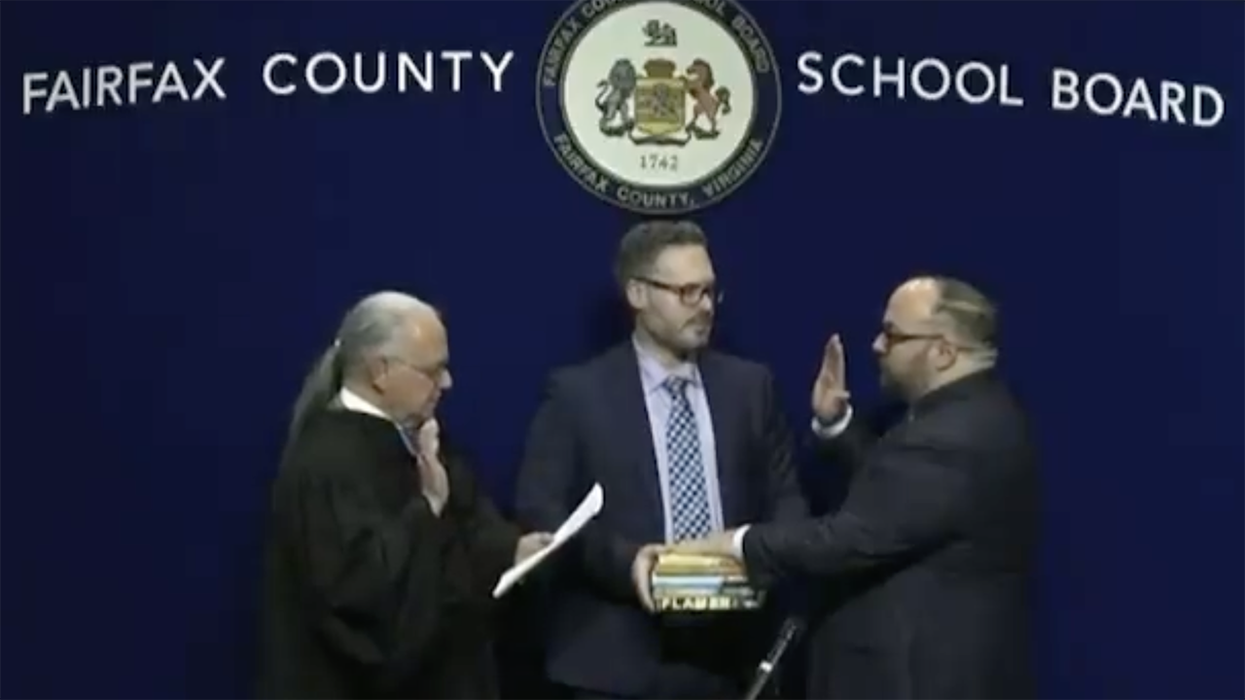 Watch: New chairman gets sworn in on stack of porn he wants in school libraries because this is what progressives do now