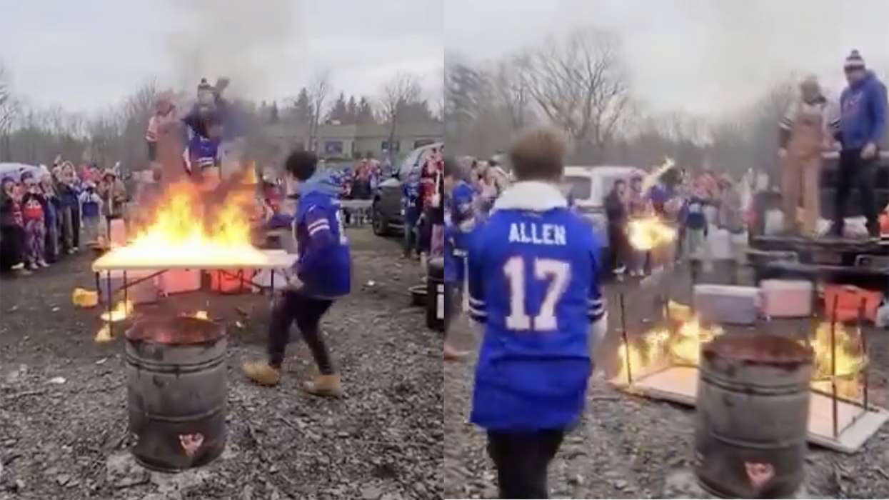 Watch: Bills fan forgets "stop, drop, and roll" as he crashes through a flaming table... wait, a flaming table?!