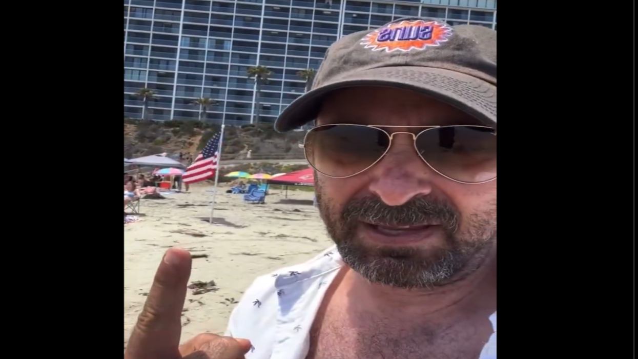 Watch: Liberal dinkus freaks out on the beach, there are too many American flags for him