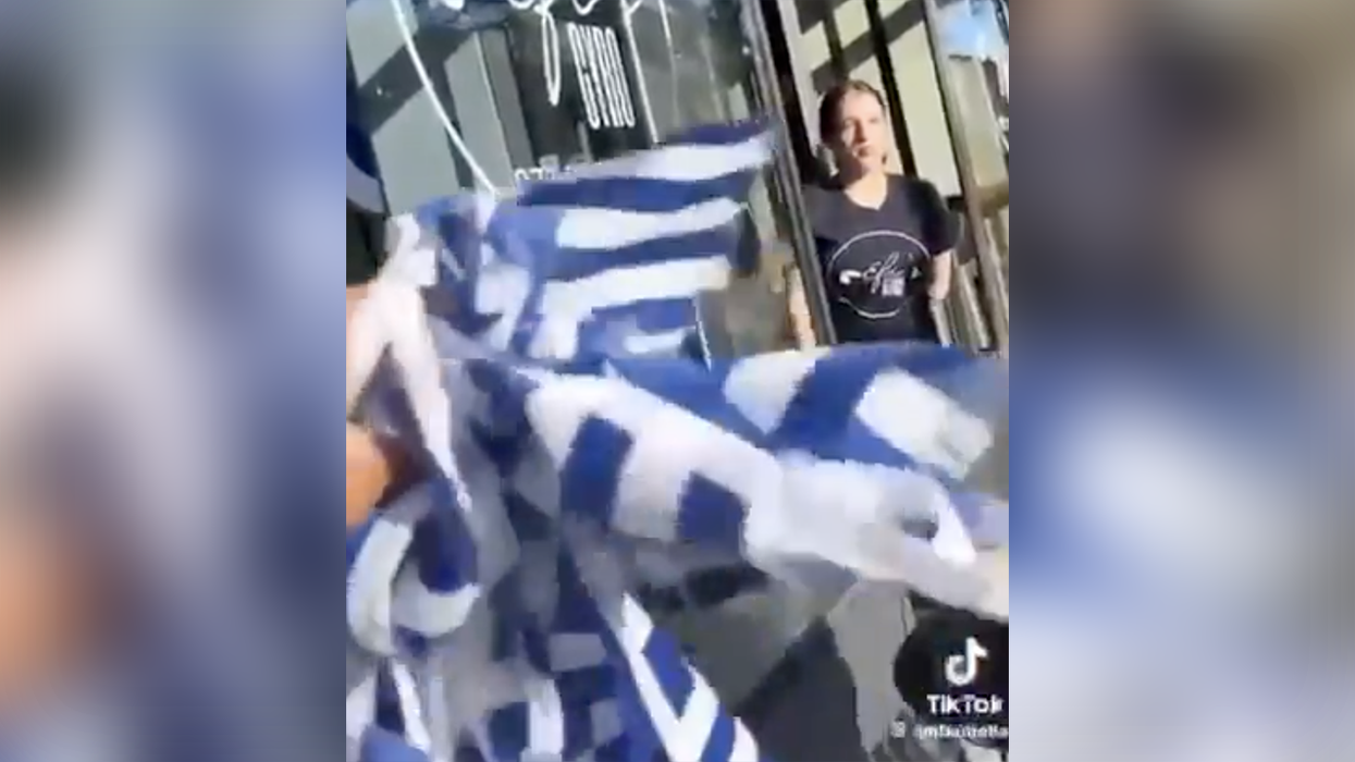 Anti-Israel nincompoop tears down what she THINKS are Jewish flags, but needs a geography lesson