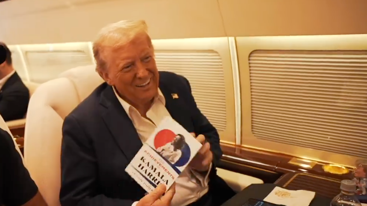 Popular podcasters give Trump a copy of "Kamala's Greatest Achievements," his reaction is priceless
