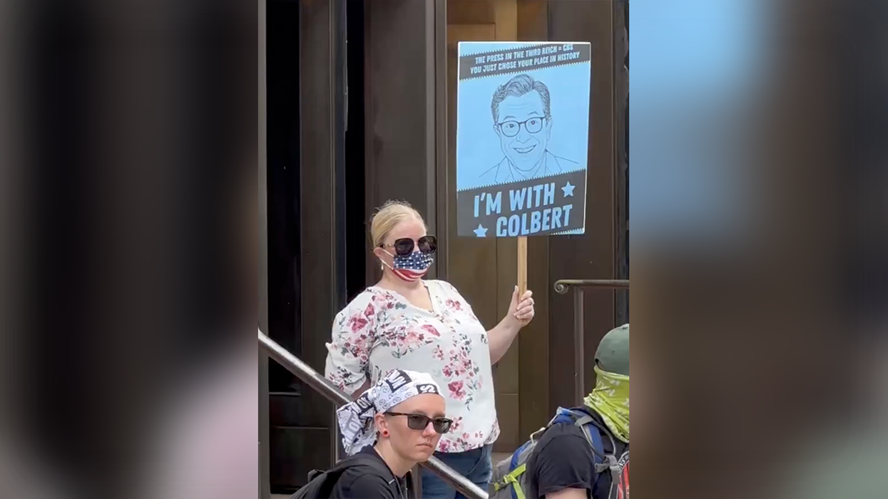 Stephen Colbert's legion of loyal fans takes to the streets to protest his cancellation. All twelve of them.