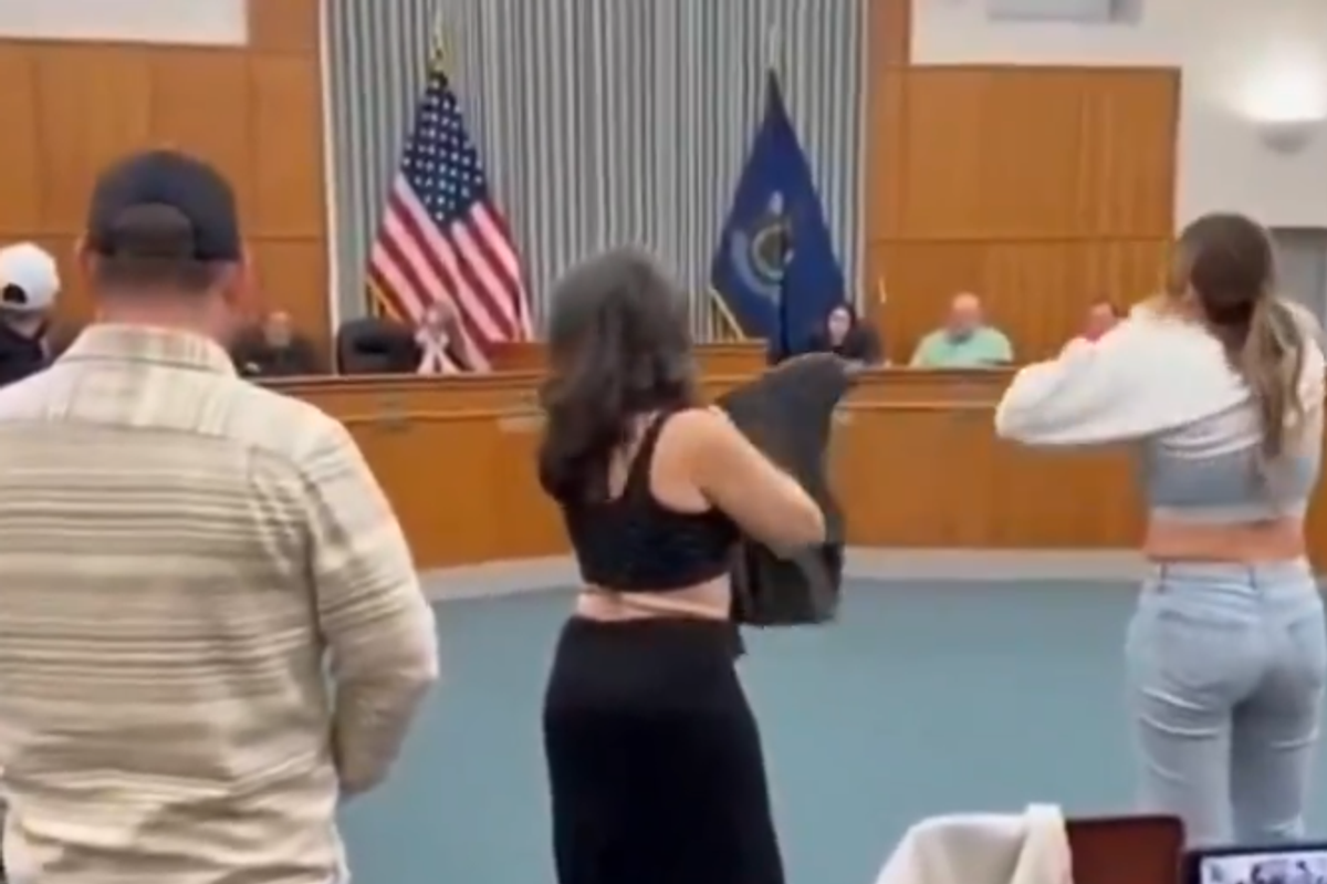 Activists start stripping during a school board meeting to point out ridiculousness of school allowing boys in the girls' locker room