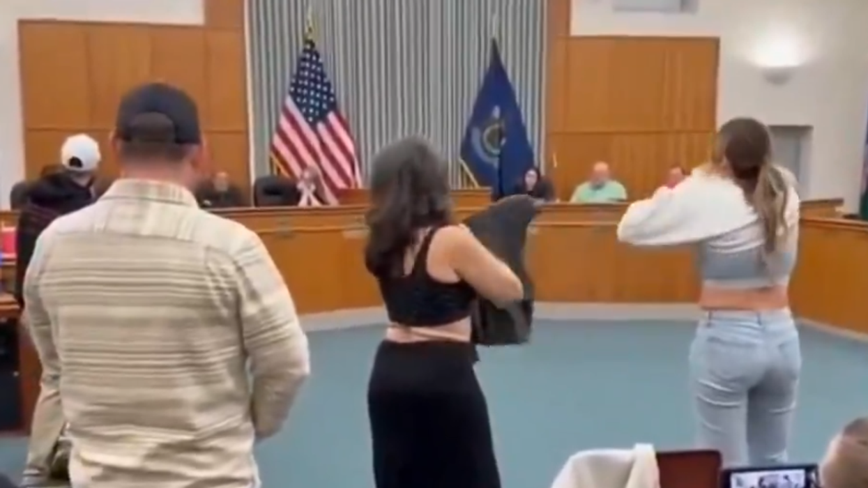Activists start stripping during a school board meeting to point out ridiculousness of school allowing boys in the girls' locker room